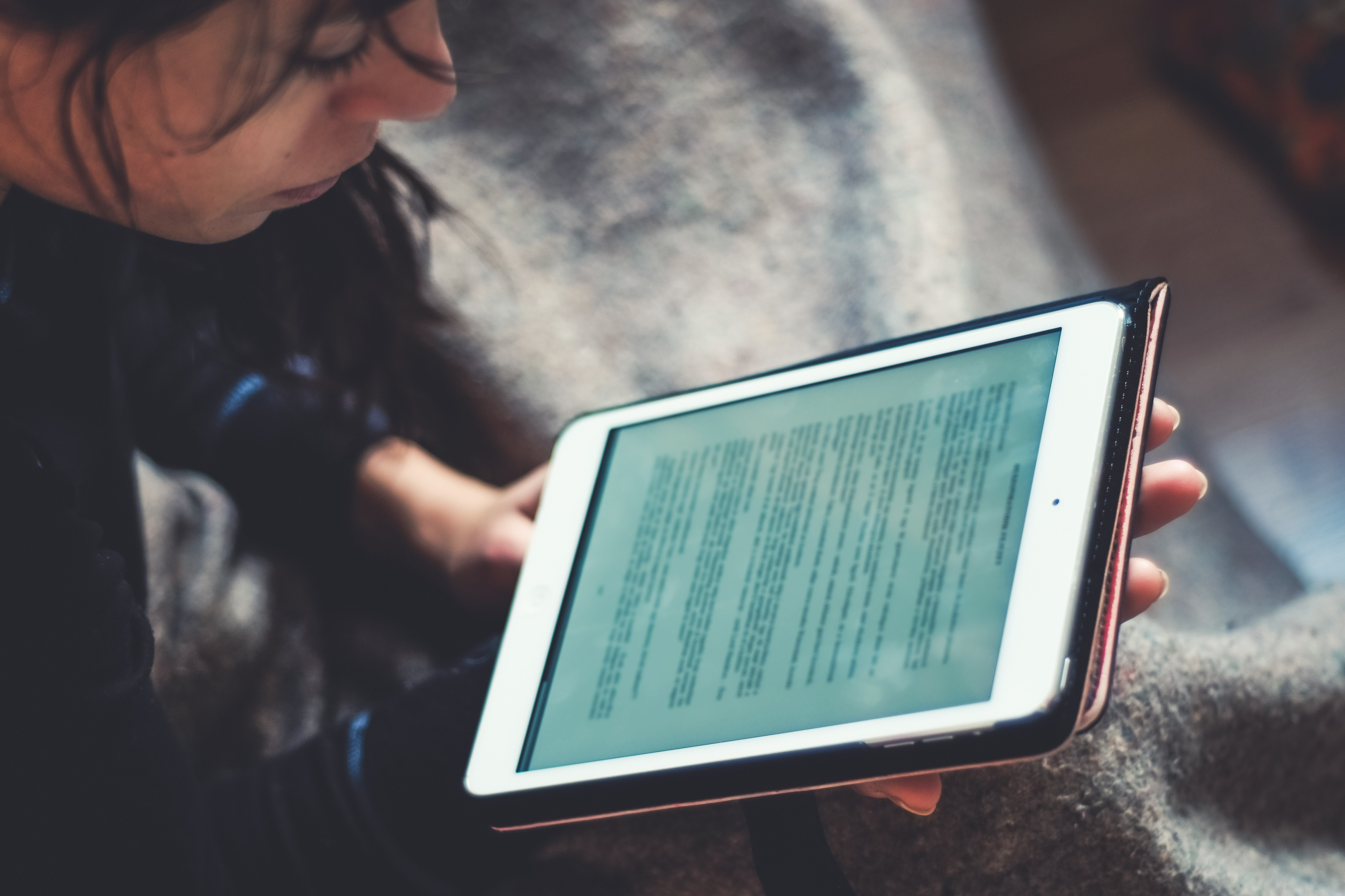 Canva - Woman Reading on Tablet Device